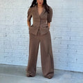 Men's brown polyester slim fit suit set with long sleeves and matching trousers on hanger