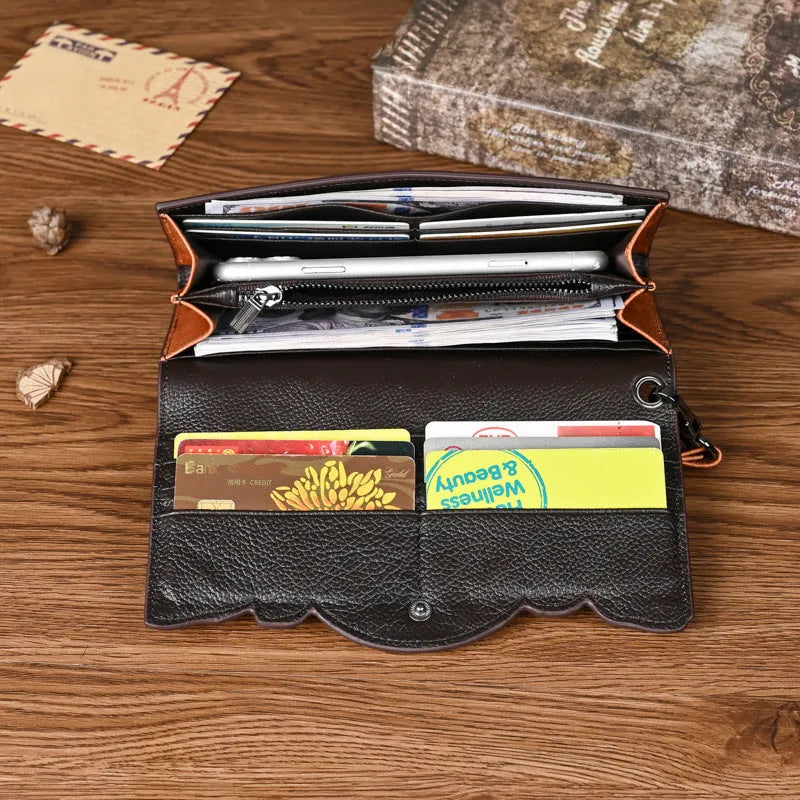 Women's brown tri-fold leather wallet with an embossed floral pattern, shown open to reveal compartments.