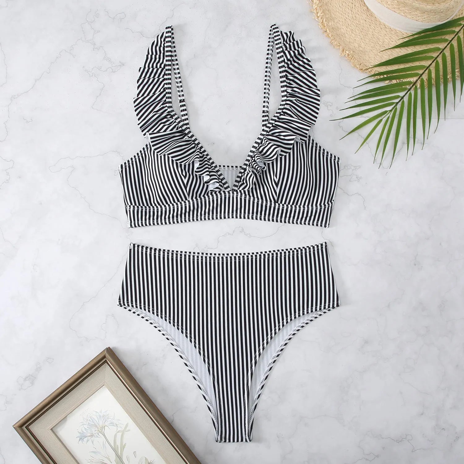 Women's black and white striped bikini with split chest design on a mannequin.