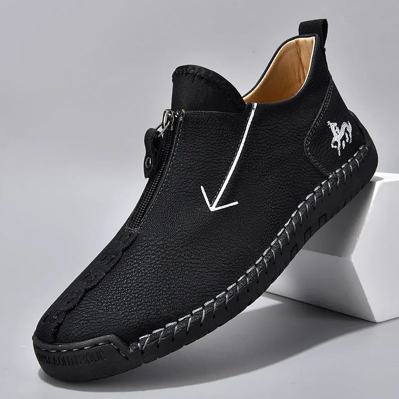 Men's black leather martin boots with a front metal zipper and round toe on a rubber sole.