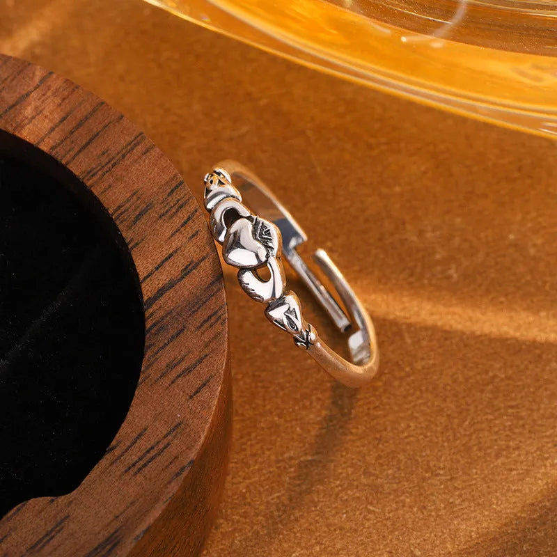 Retro silver women's open ring with a heart shape on a copper band.