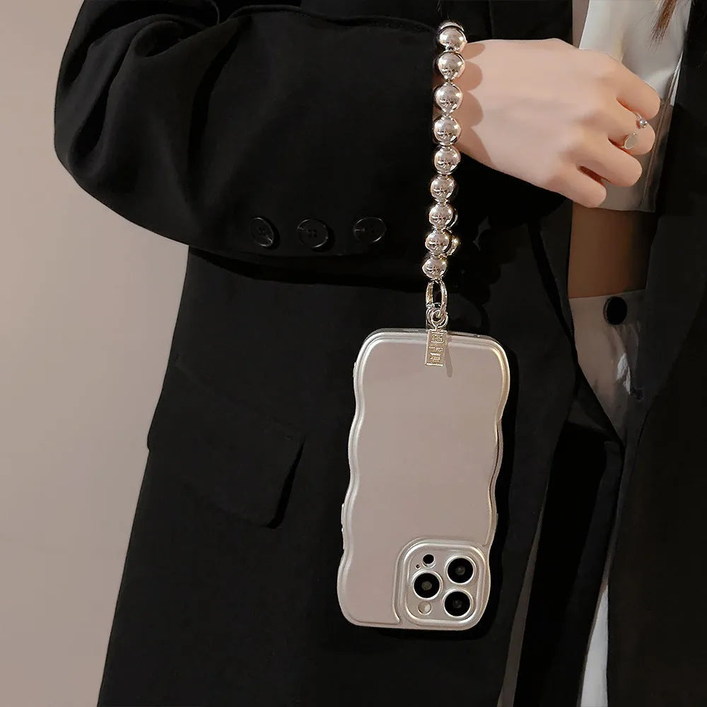 Silver metal bracket phone case for iPhone with electroplated finish and hand bead detail on gray background