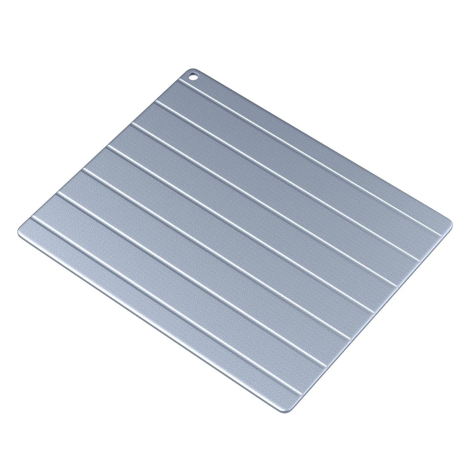 Aluminium household quick defrosting plate and separate USB cable on a kitchen counter.