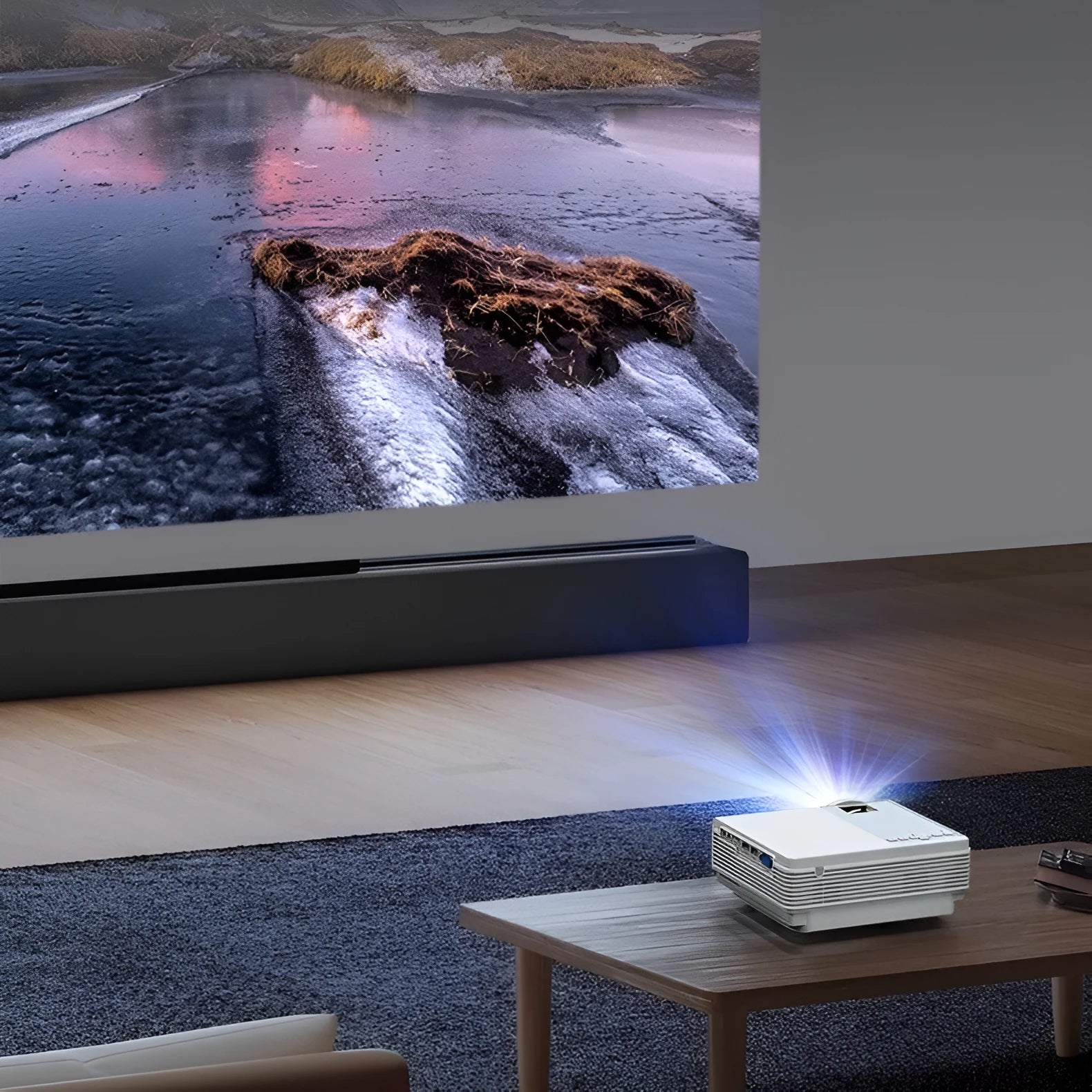 Portable HD 1080p projector in white with remote control, placed on a tabletop