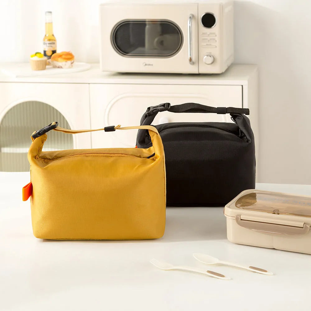 Japanese-style insulated lunch bag in Oxford cloth, shown open with a lunch box inside.