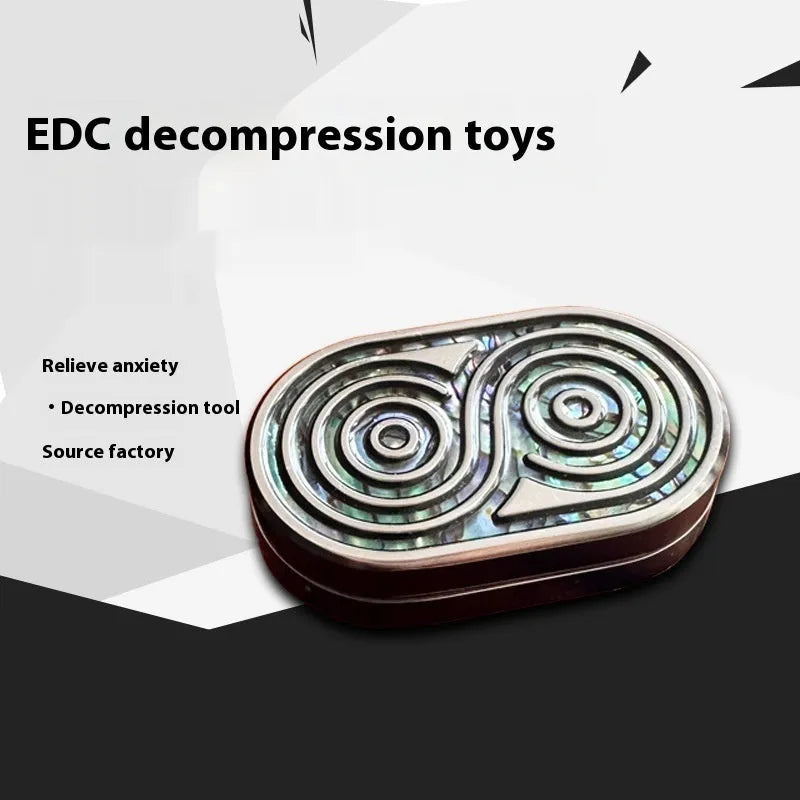 Stainless steel EDC hand push coin fidget toy in Agate Red colour on surface