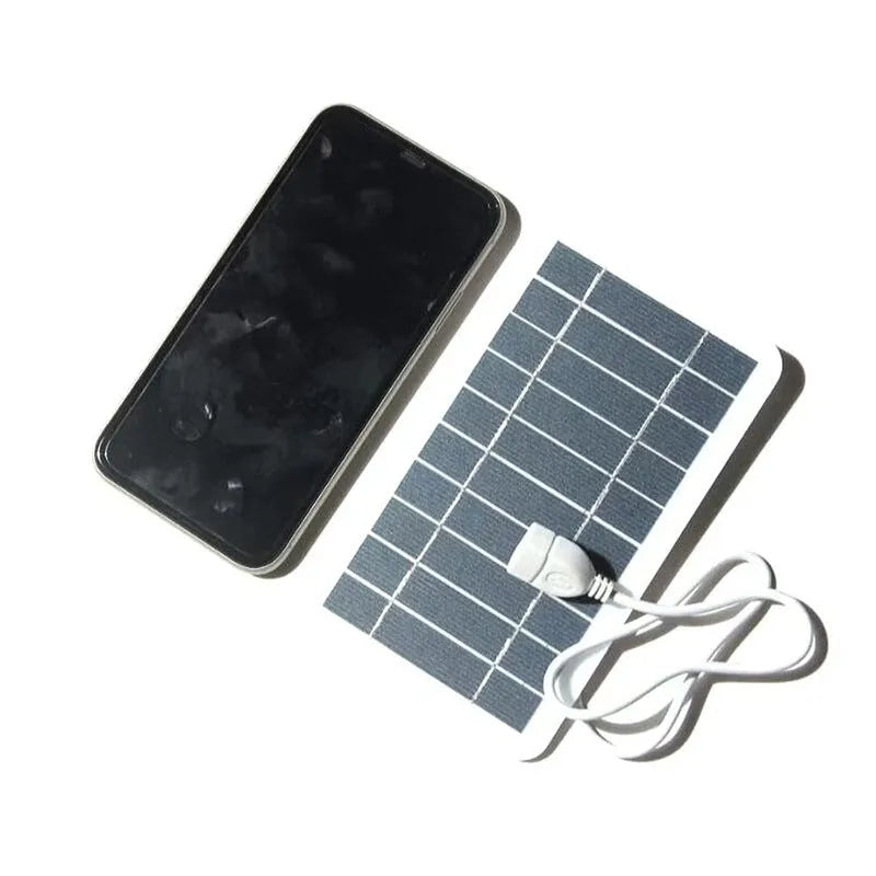 Portable 2W solar panel charger measuring 157x94mm with USB cable