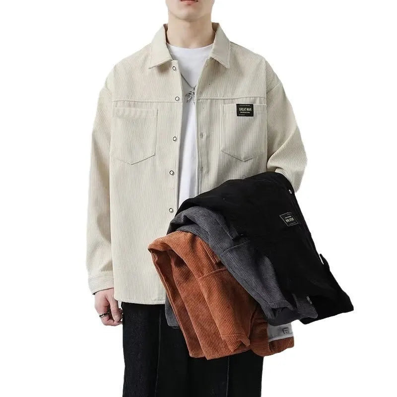 Man wearing a dark grey corduroy cardigan-style jacket with long sleeves.