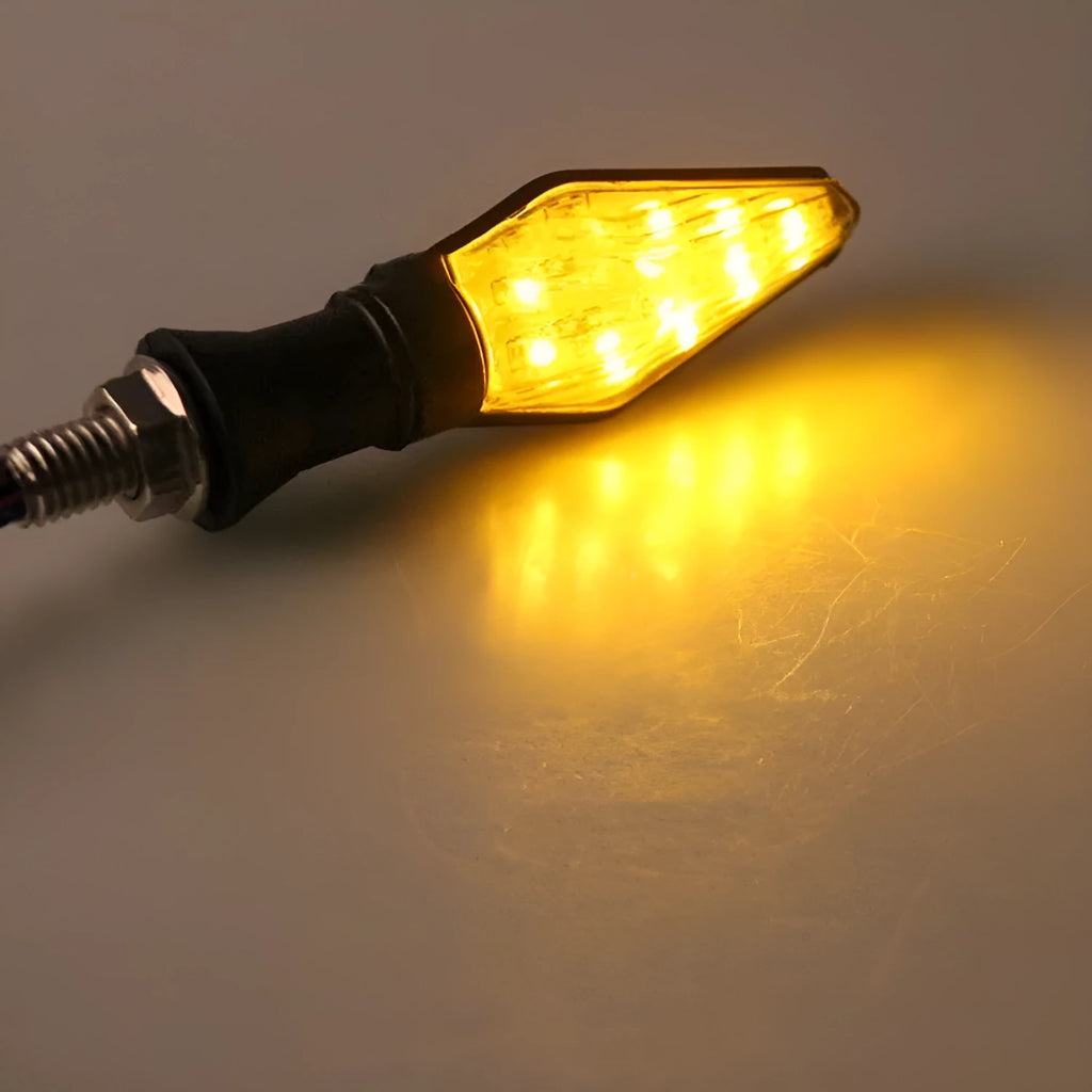 Motorcycle LED turn signal lights showing yellow and blue double-sided luminous indicators