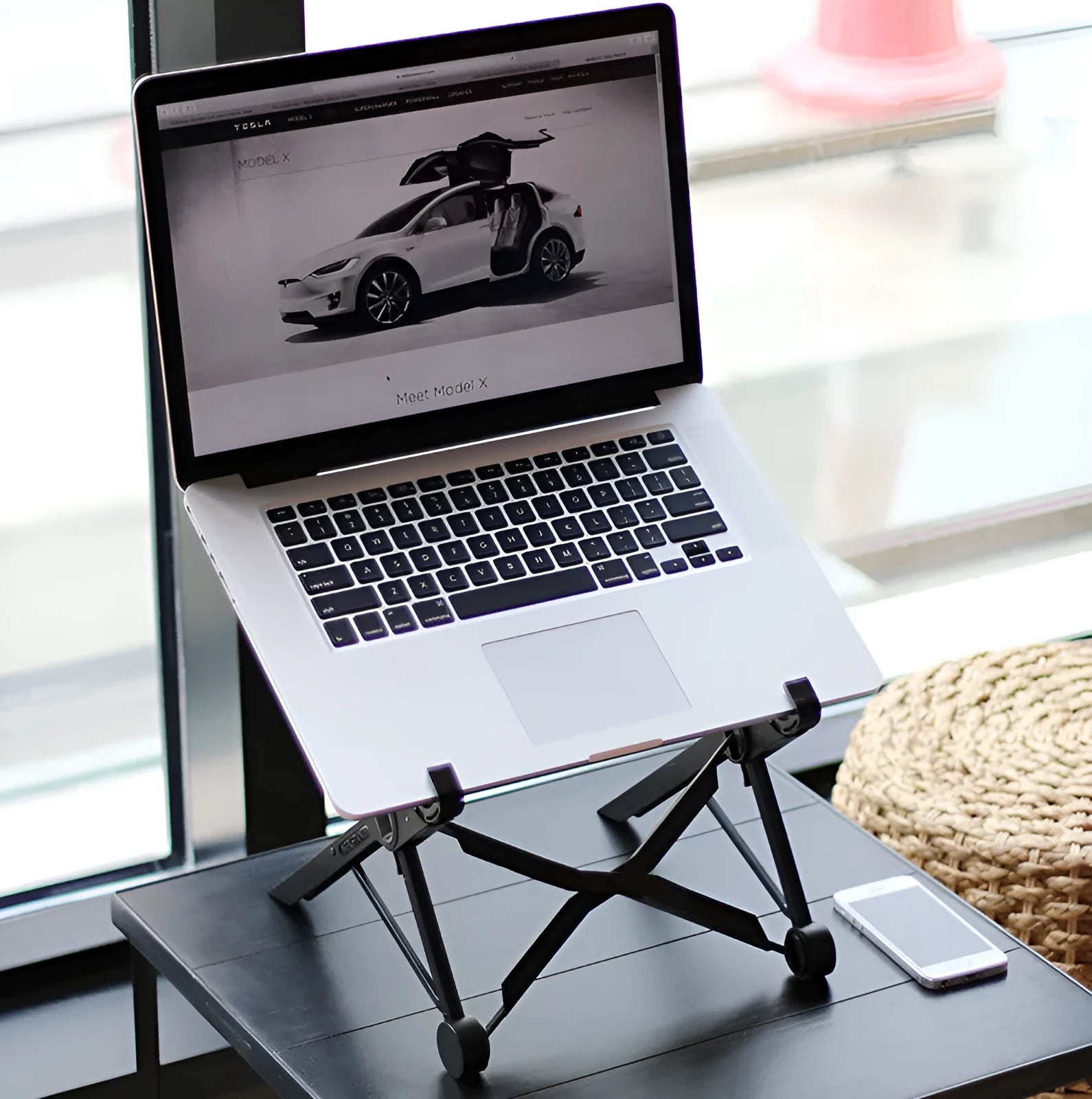 Black folding portable laptop stand made of reinforced nylon with compact folded dimensions