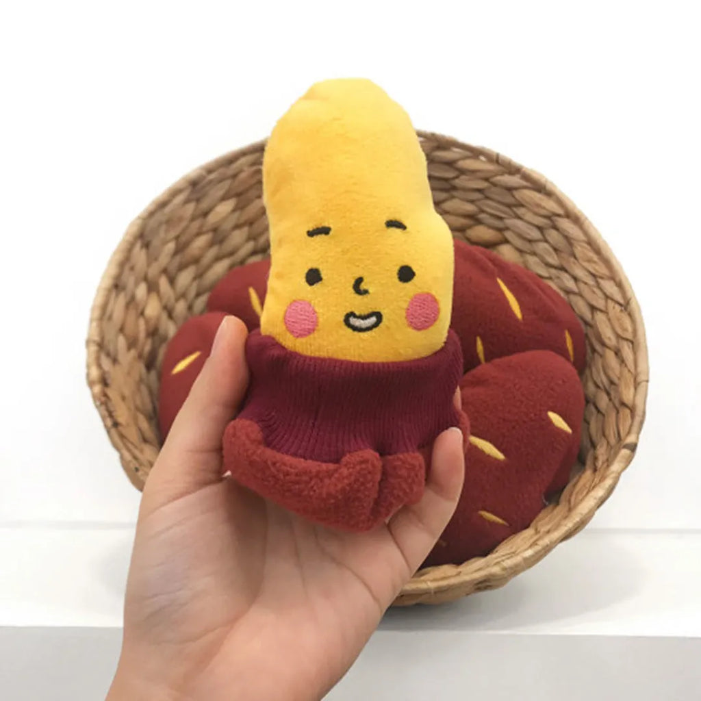 Red sweet potato-shaped dog puzzle toy with peel-open design revealing hidden treat compartments