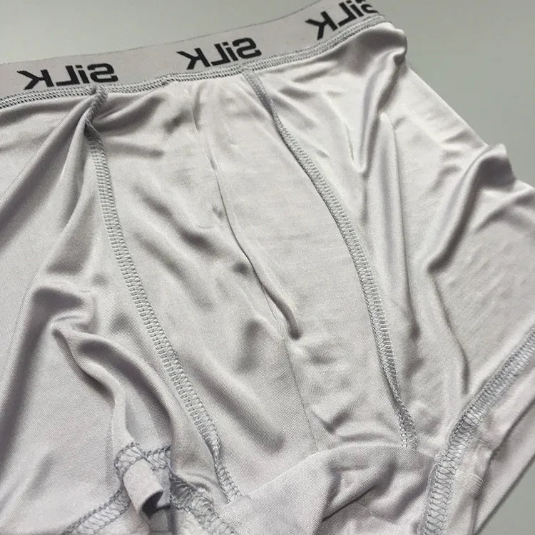 Men's loose fit silk shorts in navy blue, skin colour, and silver grey options with mid-waist design