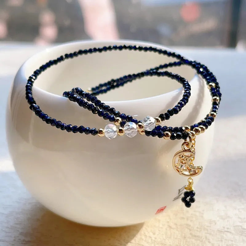 Close-up of a blue gold sand stone bracelet with three interlocking rings on a wrist.