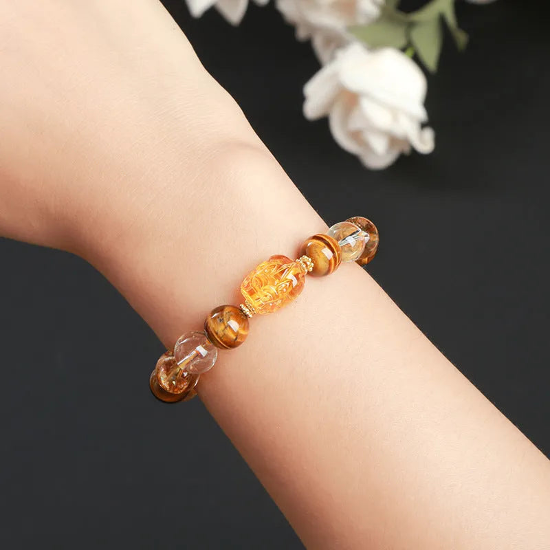 Natural yellow tiger's eye and citrine gemstone bracelet with 10mm beads and a steel Pi Xiu charm.