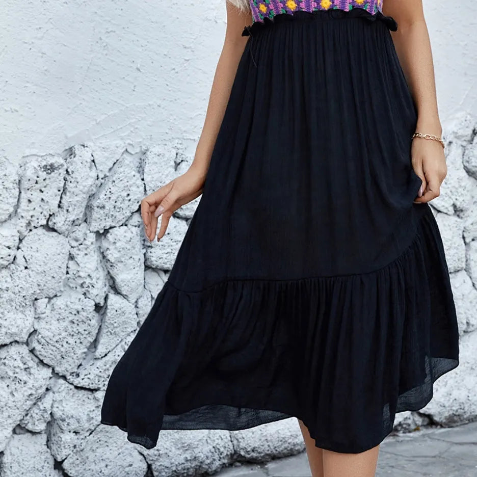 Purple sleeveless dress with raised hand-hooked floral embroidery on the fabric.