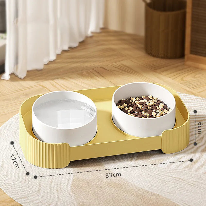 Green ceramic elevated cat bowl set with two tilted dishes on a non-slip stand.