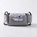 Pink tassel multifunction baby stroller bag organizer attached to stroller handles