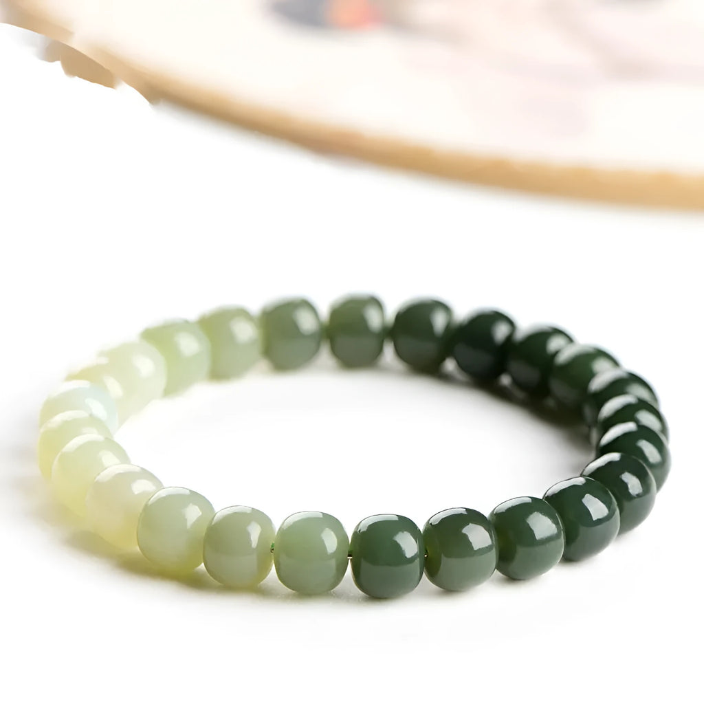 Polished Hetian jade bracelet with clear water gradient colour on wrist.