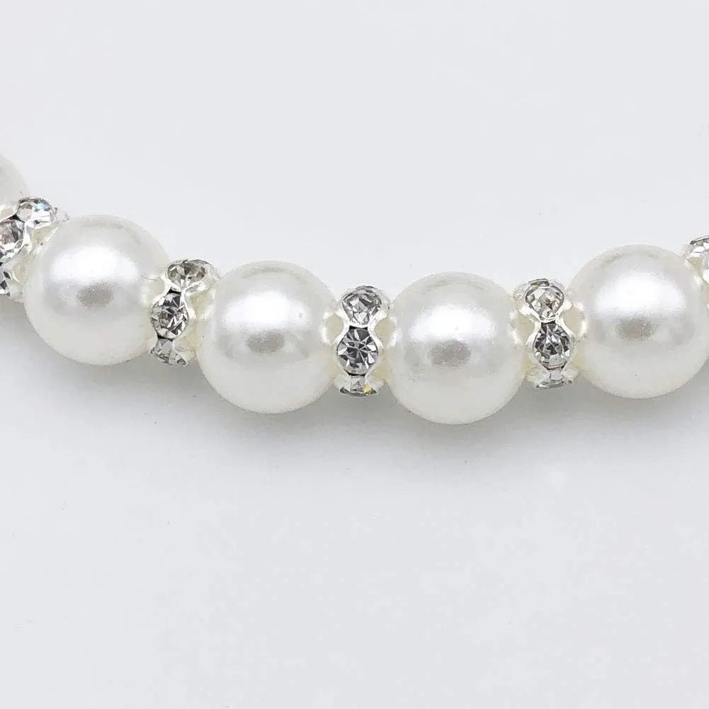 Small dog wearing adjustable pearl and rhinestone necklace with bow in blue colour