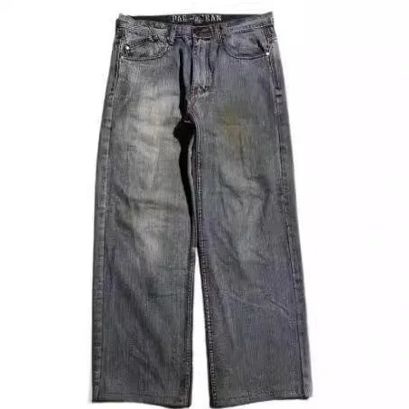 Gray washed-out denim jeans on a man, showing straight wide-leg cut and vintage workwear style.