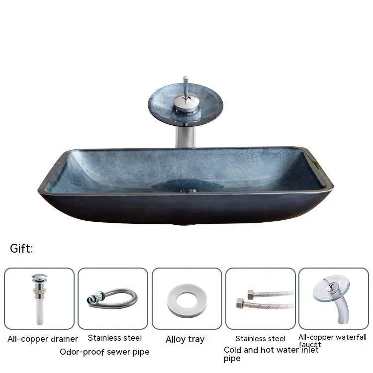Blue grey tempered glass bathroom table basin with simple design on a vanity.