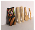 White sushi tool set with bamboo rolling mat, rice paddle, and sushi mold on a surface.