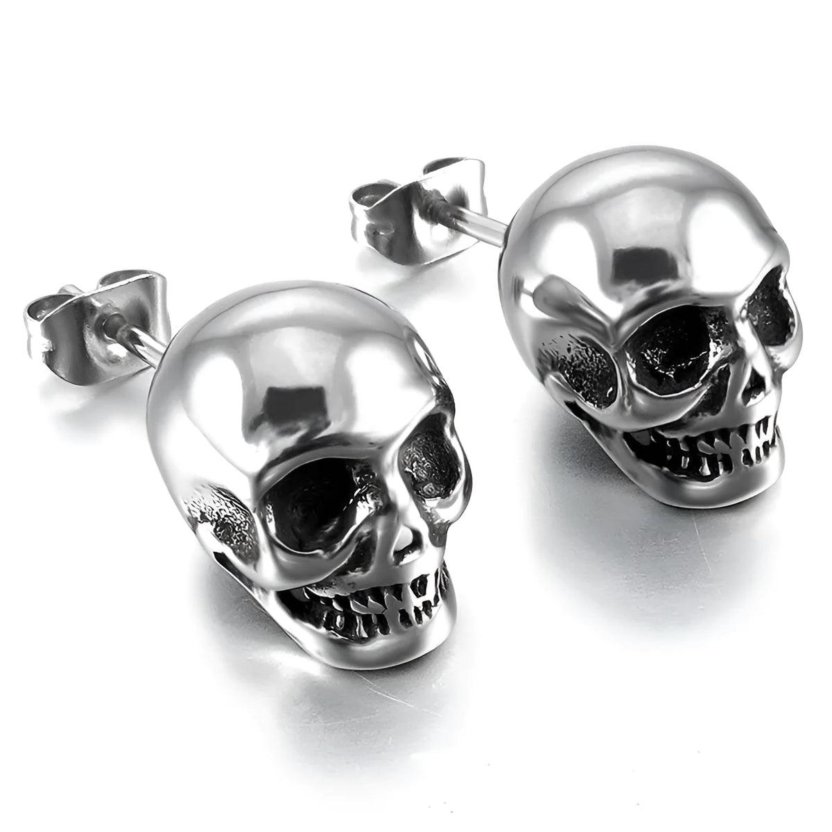 Pair of small punk skull stud earrings in black or silver white copper with push-back fittings