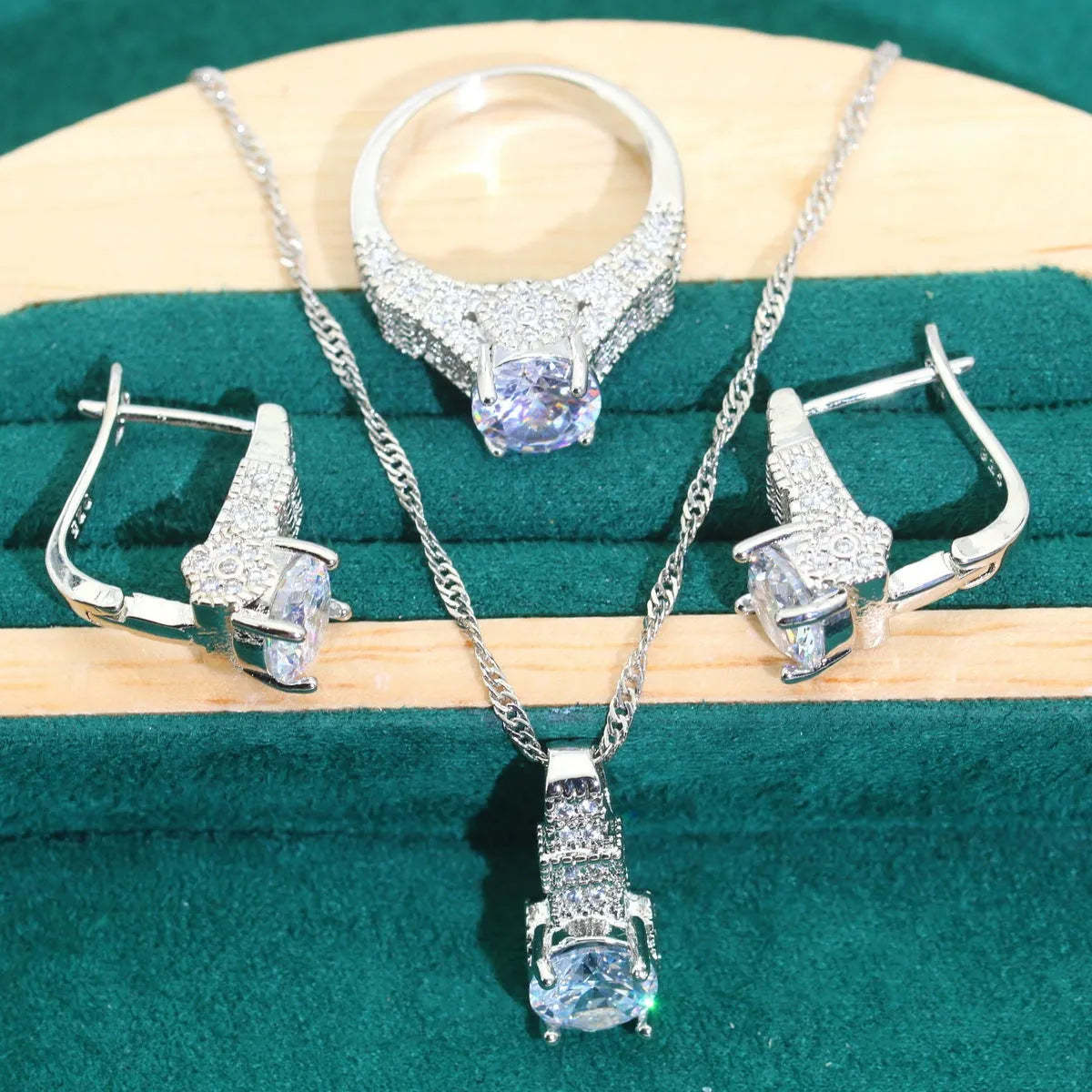 Four-piece bridal jewellery set with zircon details, water wave chains, and alloy pendants in presentation