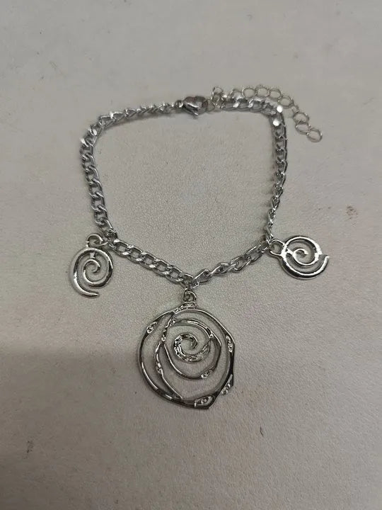 Spiral donut jewellery set showing necklace, bracelet, and ear hooks in gold or silver tone alloy