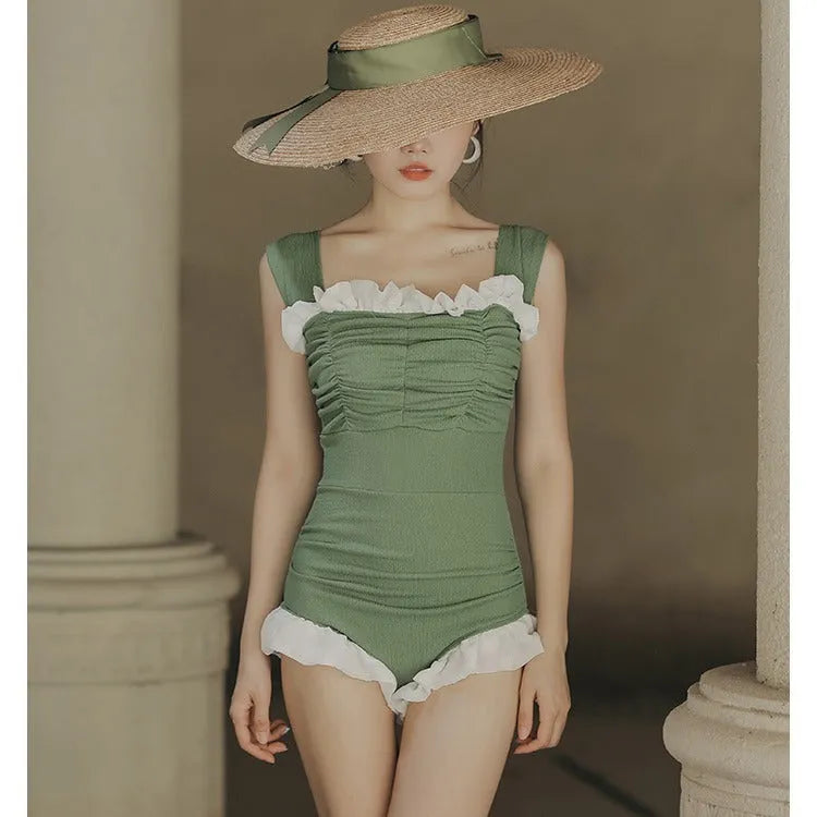 Women's black high-waisted one-piece triangle swimsuit, Korean style, on a mannequin.