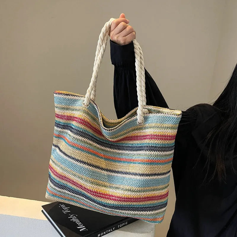 Blue woven nylon shoulder bag with single strap and straw texture.