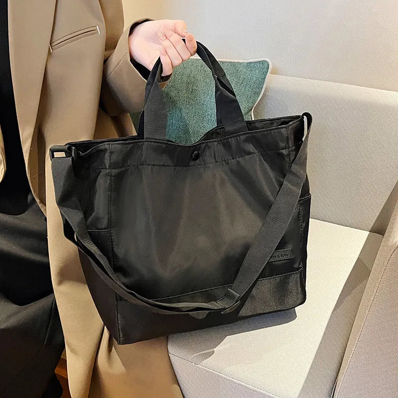 Large capacity nylon crossbody bag for women, black colour, soft material, with three shoulder straps