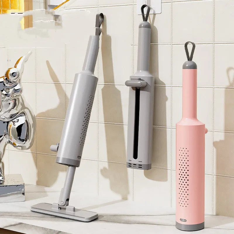 Pink rotatable self-squeeze mini flat mop with microfiber pad, shown extended to its full length.