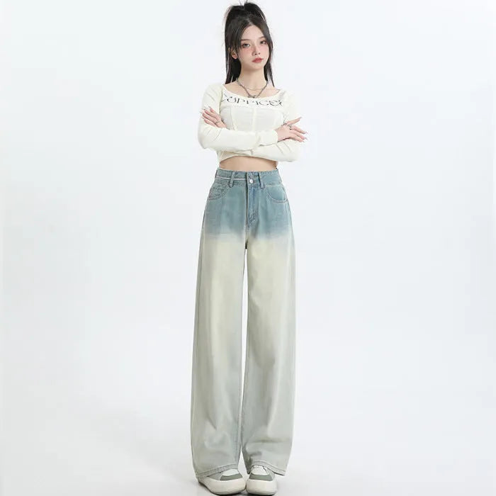 Gradient blue straight-leg denim trousers for women on a hanger, showing the wide-leg cut and colour fade.