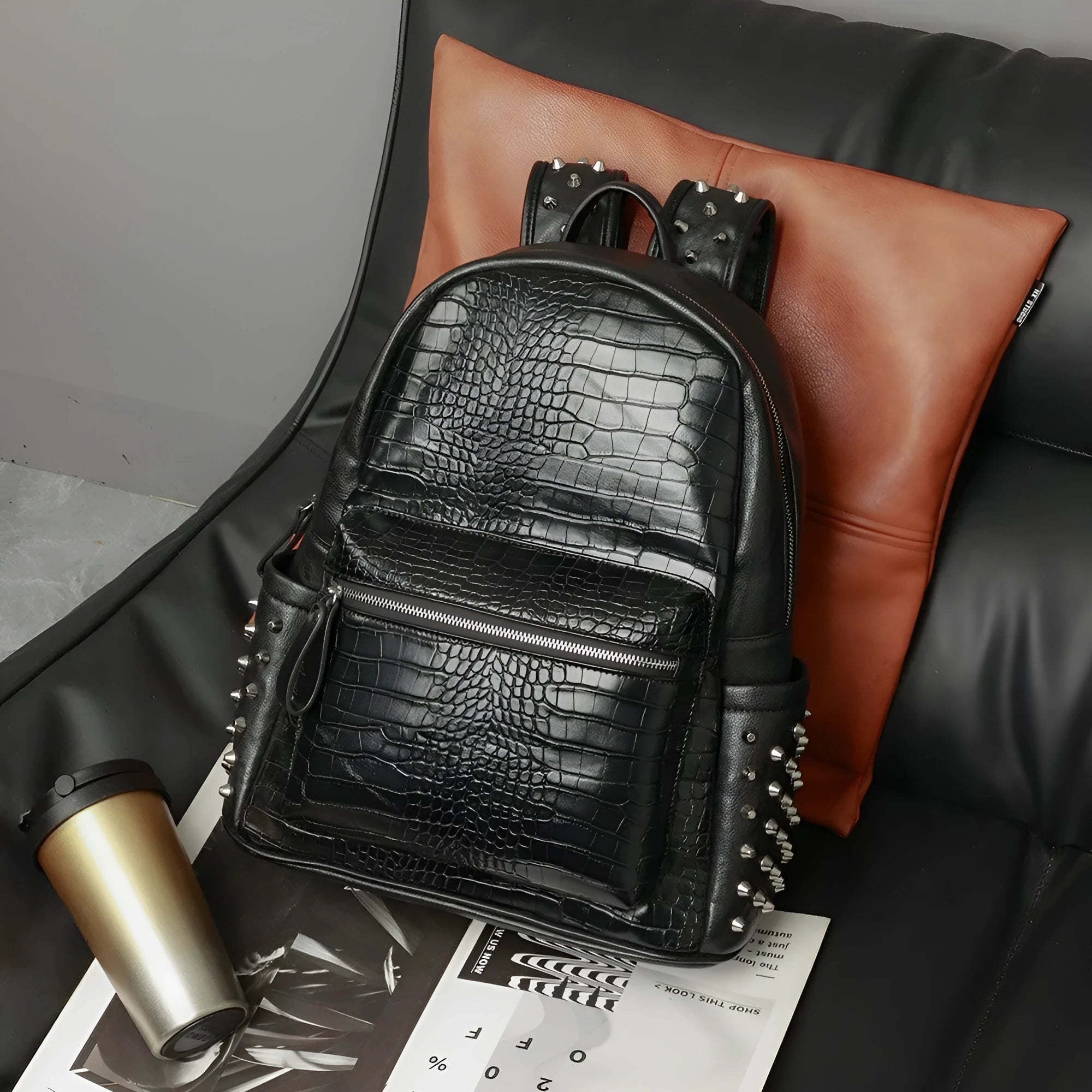 Black oil wax leather waterproof computer schoolbag with rivets, showing large 36-55L capacity.