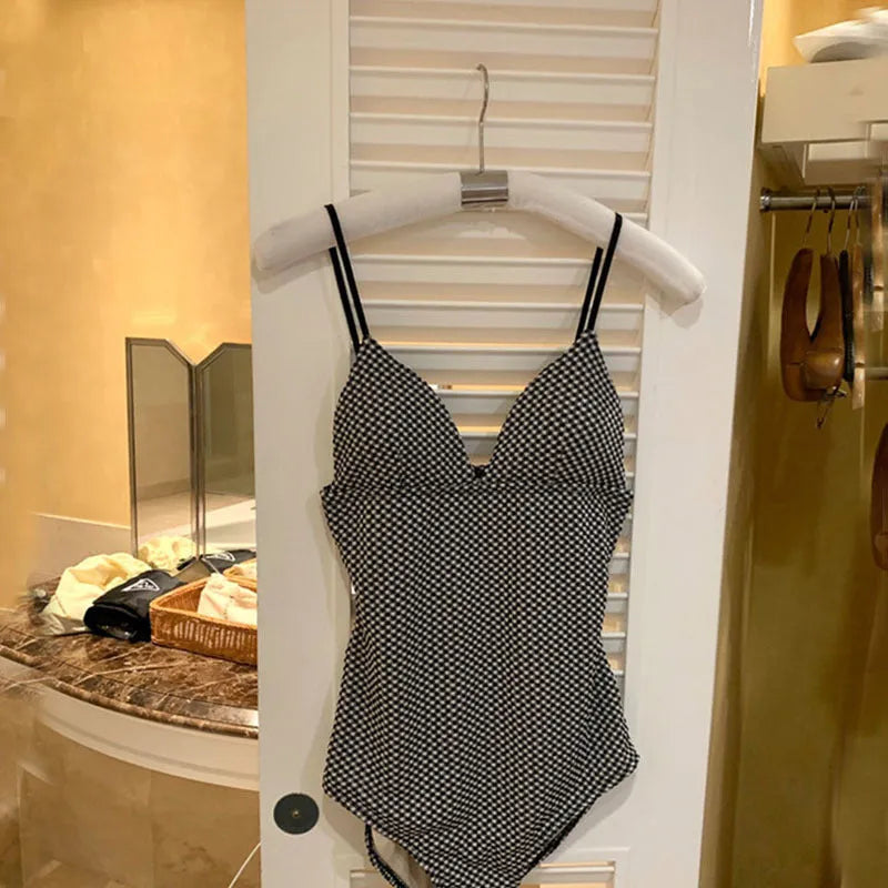 Blue and black cover-belly one-piece swimsuit for small chests on a mannequin.