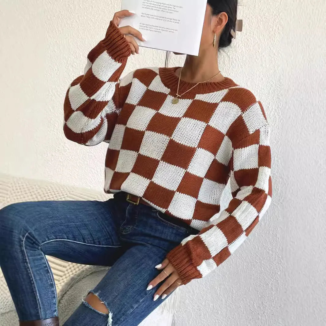 Dark brown plaid pattern long sleeve pullover sweater on a hanger.