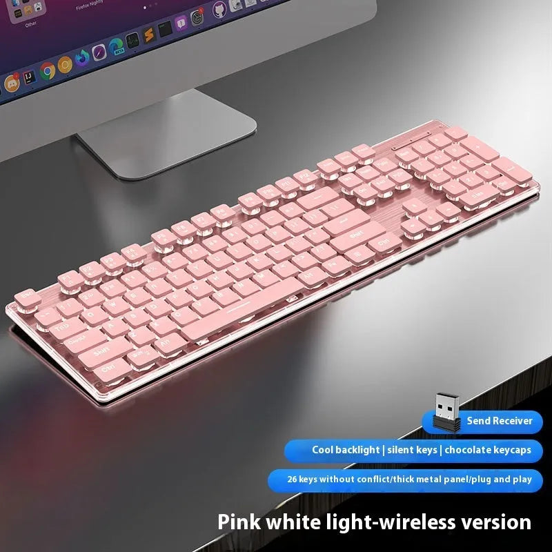 Wireless mute Bluetooth keyboard in pink or white on a desk next to a phone.
