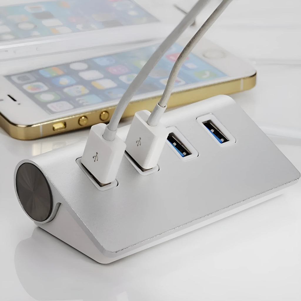 Silver aluminium alloy four-port USB 3.0 hub on a desk with cables connected, 98x58x30mm