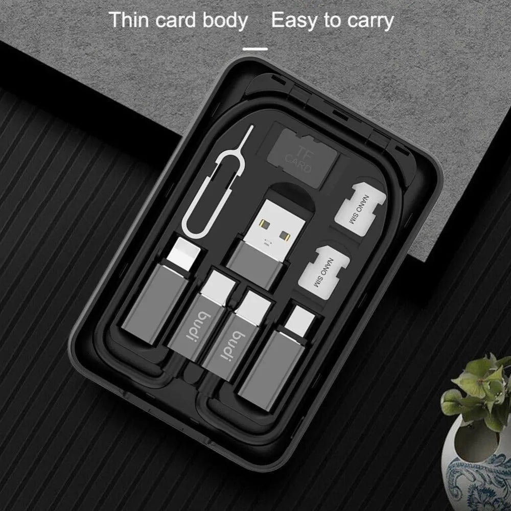 Black budi multi-functional power bank with cables and SIM kit on a table