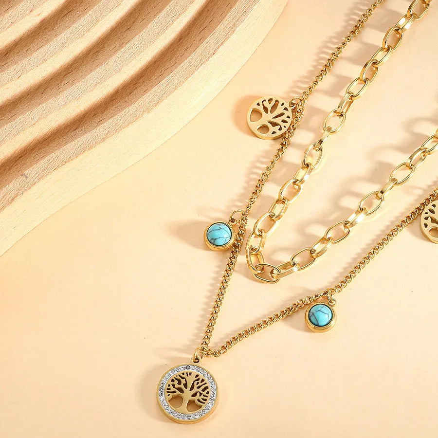 Gold titanium steel multi-layer box chain necklace with turquoise accent on model