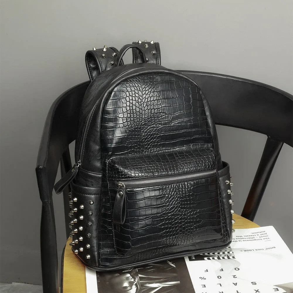 Black oil wax leather waterproof computer schoolbag with rivets, showing large 36-55L capacity.