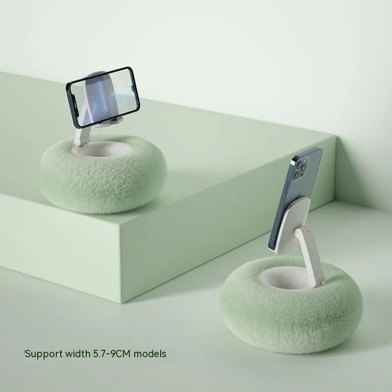 Adjustable rotating phone and tablet bracket on a desk, showing the clamp and fabric base.