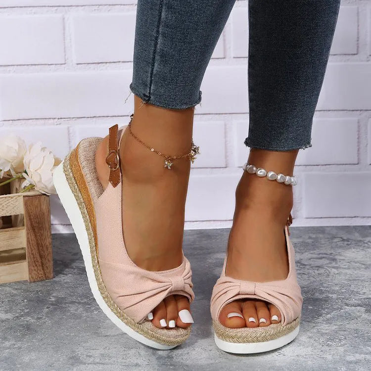 Peep toe platform sandal with one-line buckle strap, cloth upper, rubber sole, shown in black.
