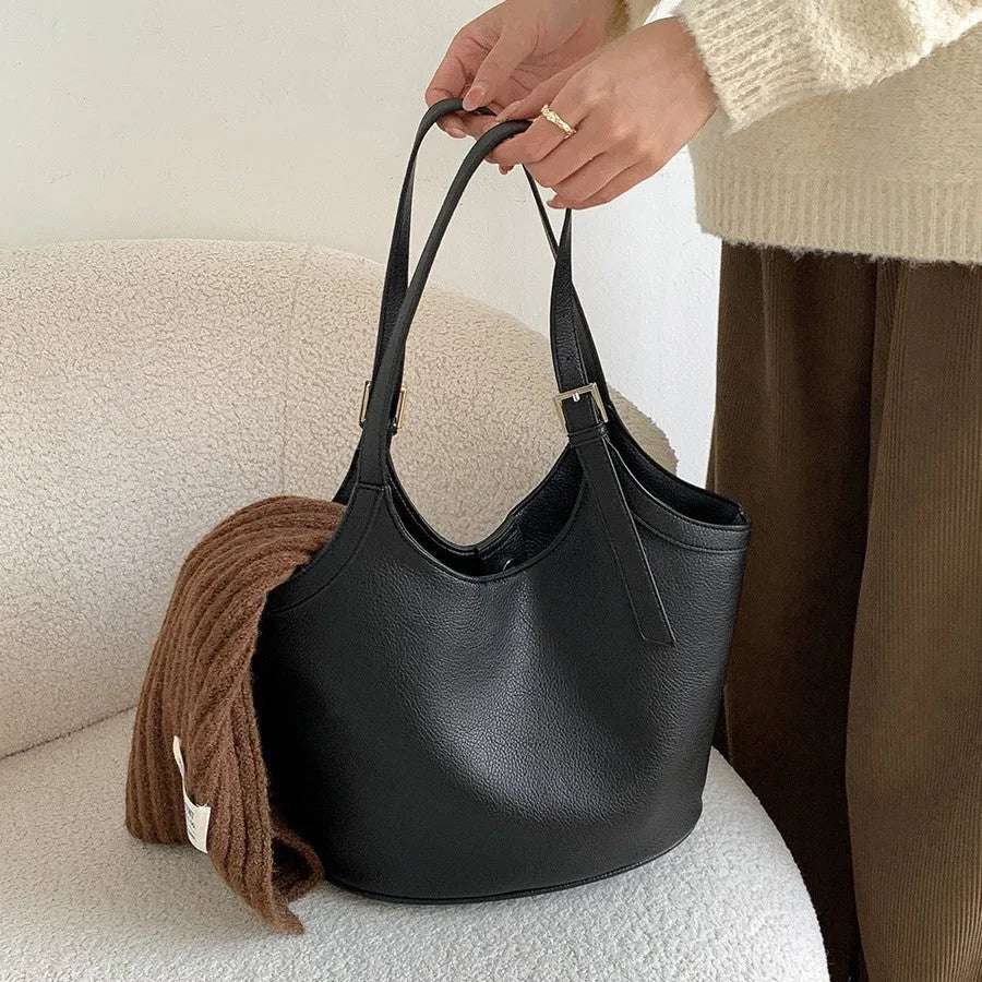 Idle Style light retro PU soft leather large capacity commuter shoulder bag in black with bucket shape and double straps