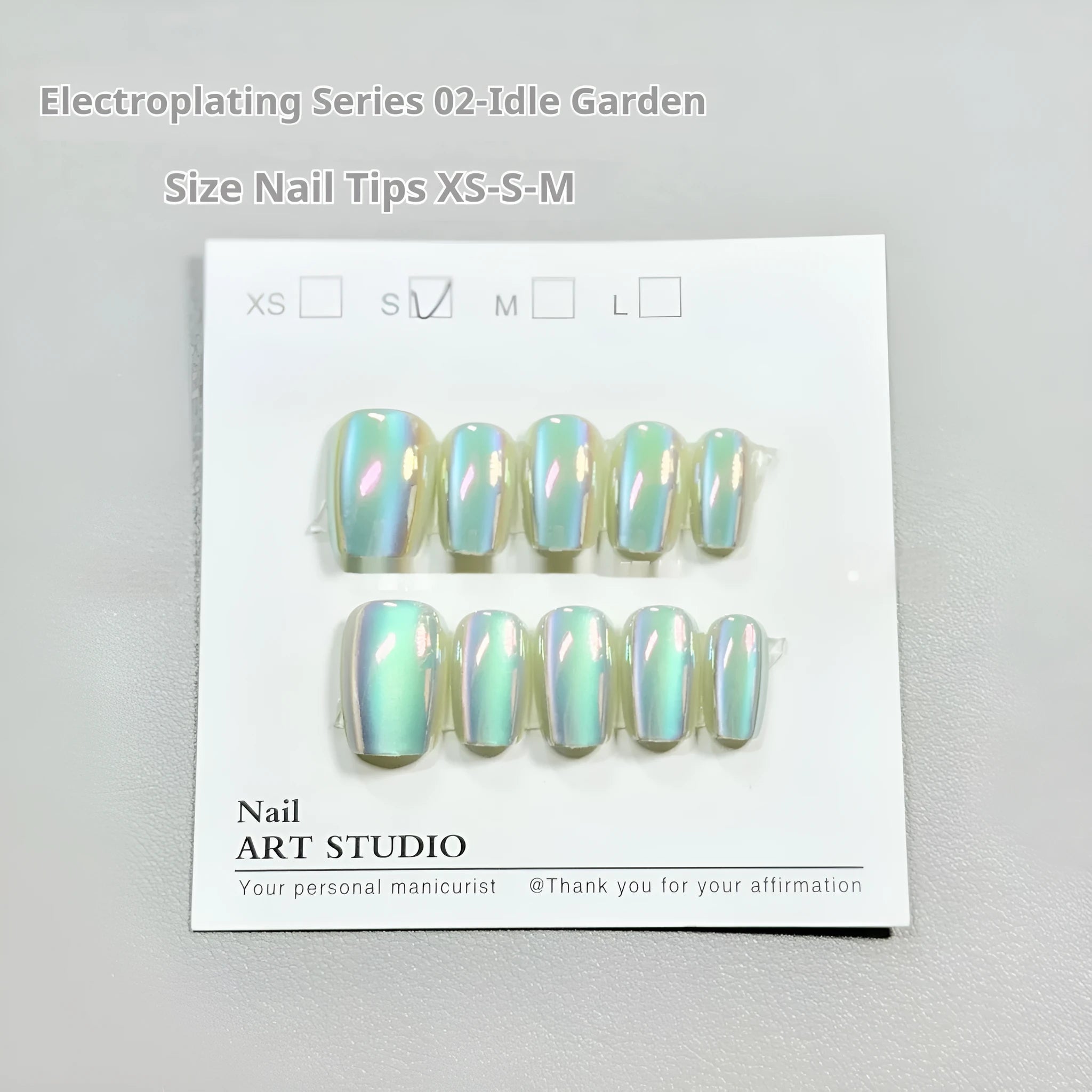 Electroplated Cat's Eye aurora effect false nail set in short ladder sizes on a display card.