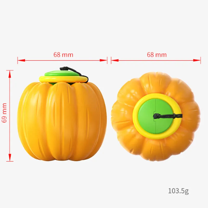 Pumpkin-shaped orange dog chew ball with squeaker for small dogs on a wooden floor.