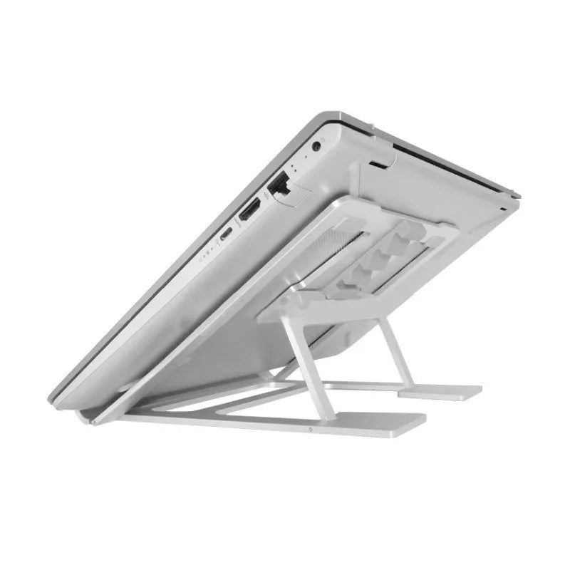 Foldable silver aluminium laptop stand with silicone grips on a desk, showing adjustable angle