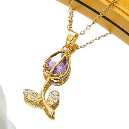 Gold-toned titanium steel necklace with a floral tulip pendant on an O-ring chain.