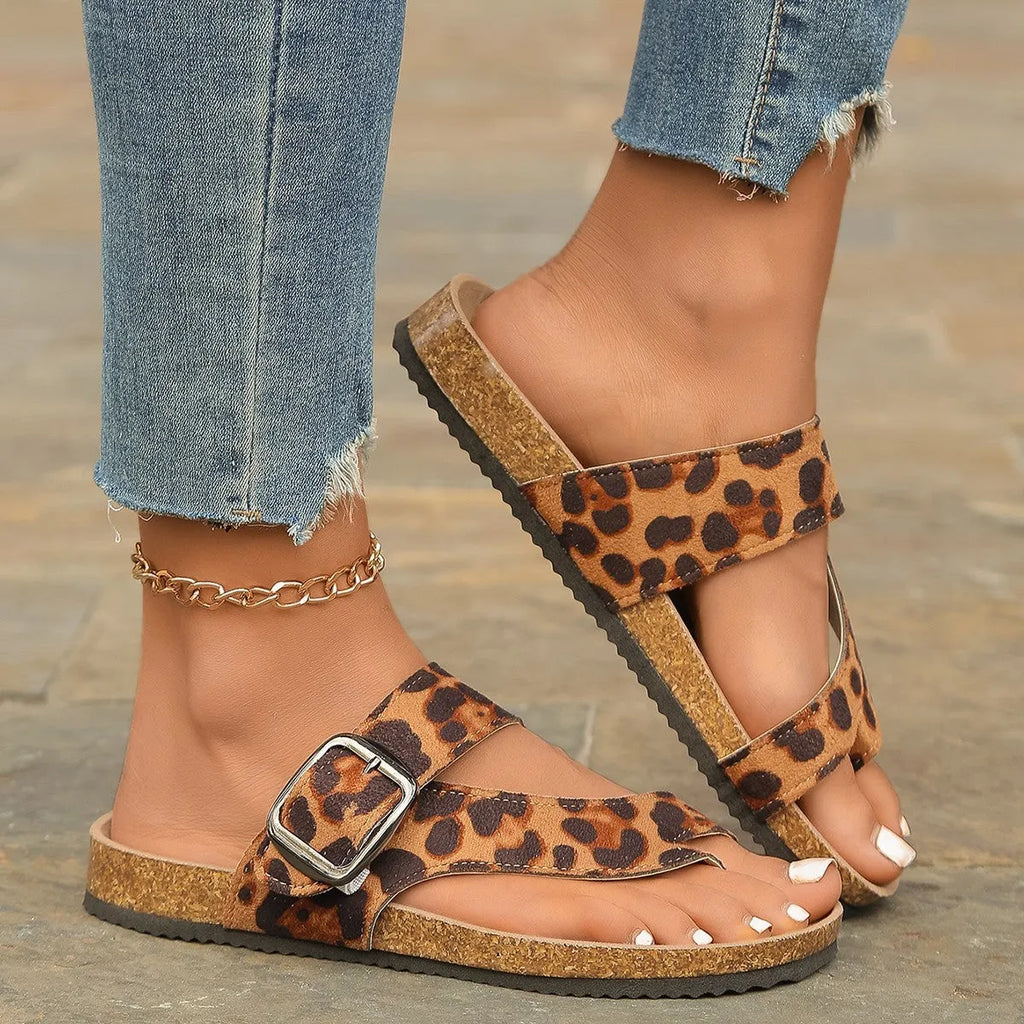 Leopard print Roman style slippers with toe covering and wooden sole.